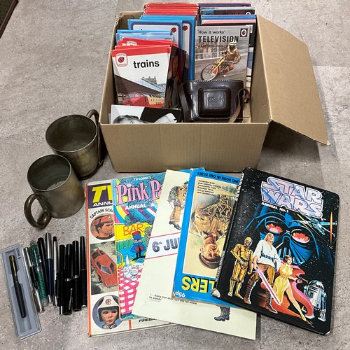12 - Box of Ladybird books, camera, 2 EPNS mugs and pens.