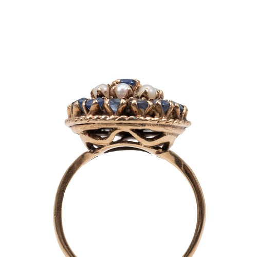 50 - 9ct gold sapphire and opal dress ring (by repute Russian) of circular form, the central sapphire sur... 