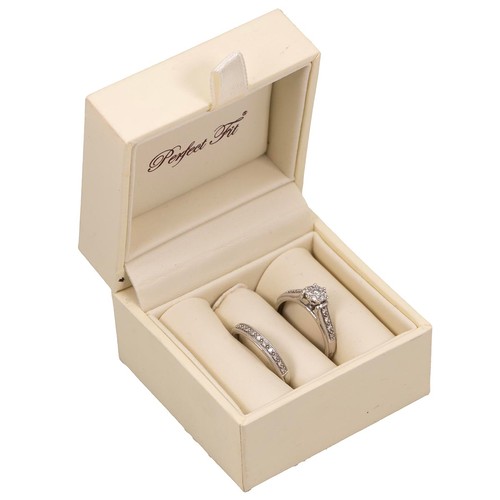 77 - A 9ct white gold wedding and engagement ring, each set with diamonds, size P, 4.2 grams.
