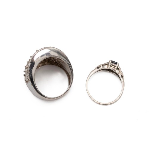 99 - Two silver gem set rings one set with a central set sapphire flanked with diamonds to the shoulder, ... 