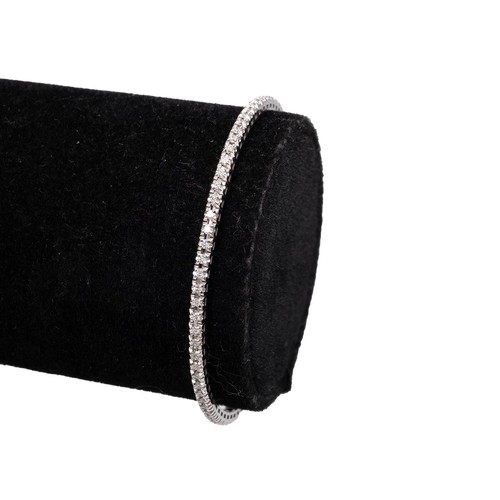 154 - 14ct white gold (tested) diamond tennis bracelet set with brilliant-cut diamonds and a push-pull cla... 
