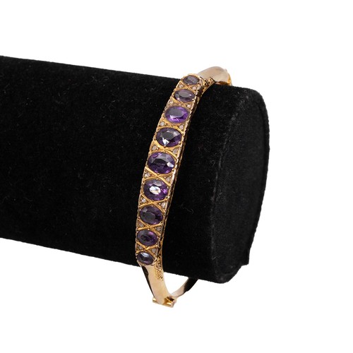 158 - 9ct gold hallmarked bangle, set with nine graduating amethysts flanked by six diamonds set in a rais... 