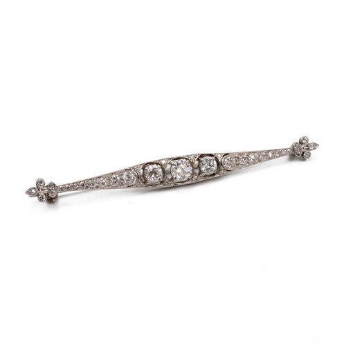 163 - 18ct white gold (tested) with 9ct white gold clip (tested) diamond encrusted bar brooch, the central... 