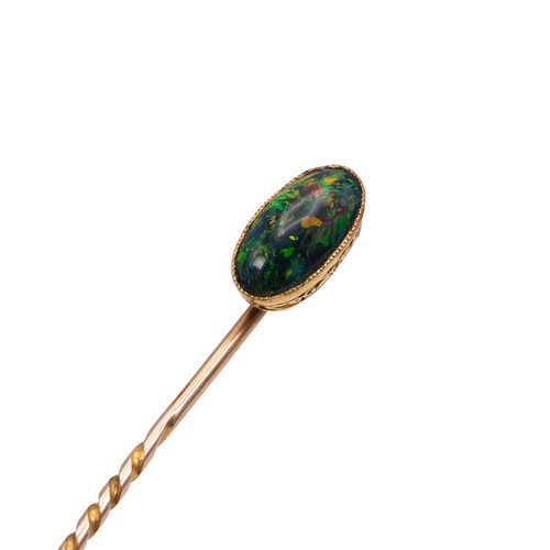 A black opal stick pin, the opal of oval form set in 18ct gold (tested ...