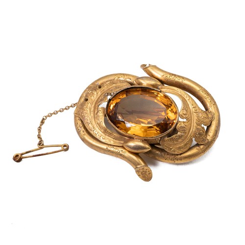 172 - A 19th-century brooch set with citrine decorated with acanthus and engraved decoration.