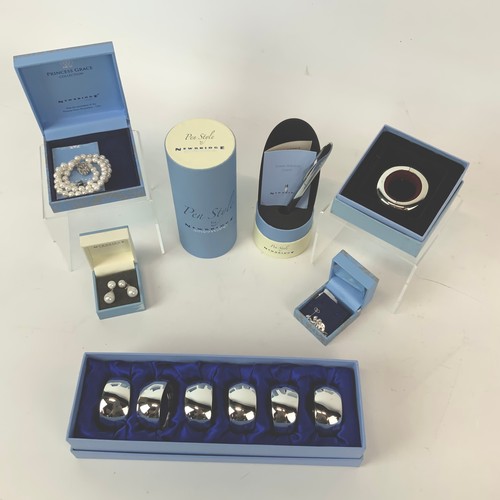 253 - An assortment of Newbridge metalware including napkin rings, boxed pen and costume jewellery etc.