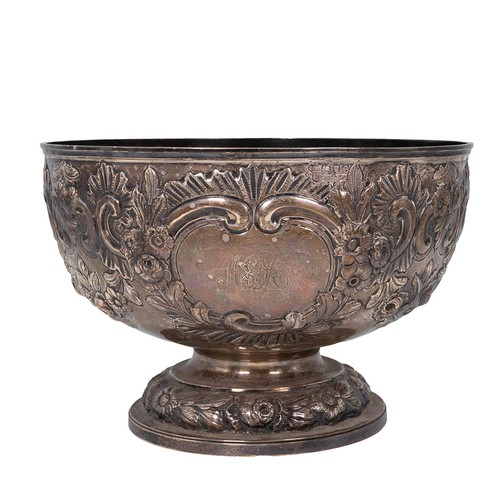 359 - A silver bowl with embossed rose and foliate decorations, engraved cartouche to Arthur E Mills, on s... 