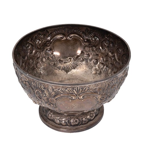 359 - A silver bowl with embossed rose and foliate decorations, engraved cartouche to Arthur E Mills, on s... 