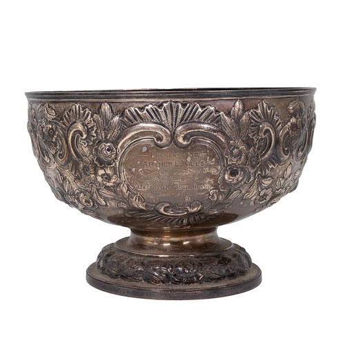 359 - A silver bowl with embossed rose and foliate decorations, engraved cartouche to Arthur E Mills, on s... 