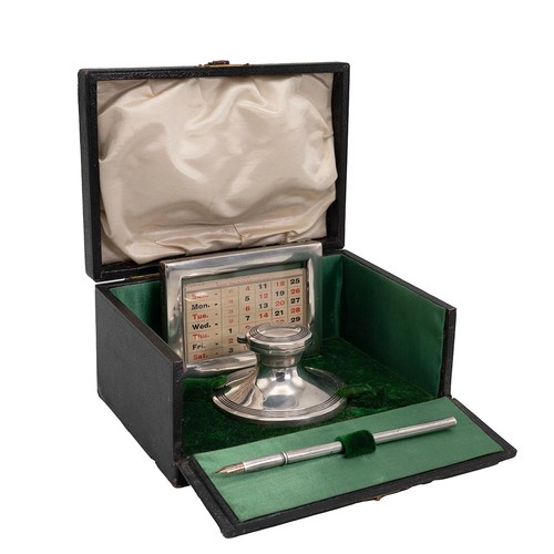 407 - A desk set in a leather box comprising an inkwell, hallmarked Birmingham 1912, complerte with tolled... 