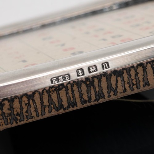 407 - A desk set in a leather box comprising an inkwell, hallmarked Birmingham 1912, complerte with tolled... 