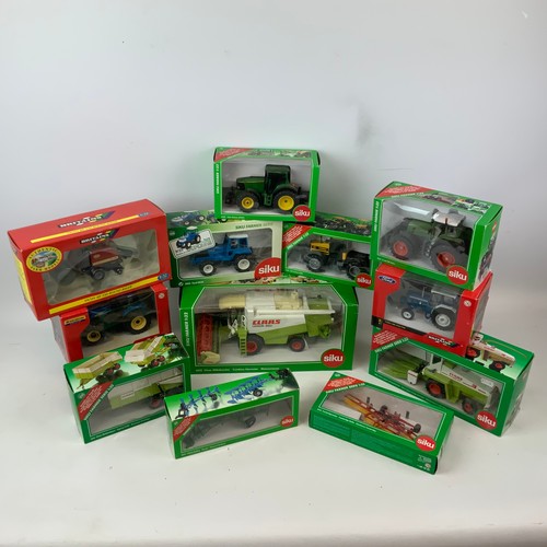 757 - A collection of die-cast boxed farm models, including Britains and SKIU, as well as New Holland, Joh... 