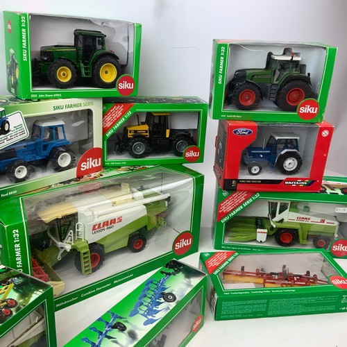 757 - A collection of die-cast boxed farm models, including Britains and SKIU, as well as New Holland, Joh... 
