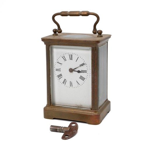 881 - A vintage brass carriage clock with bevelled glass sides, a white enamel face with Roman numeral inc... 