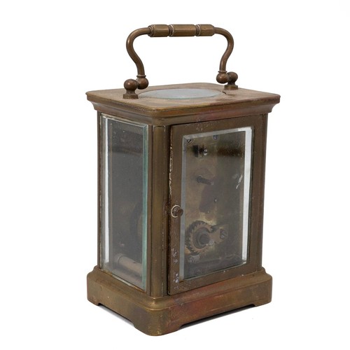 881 - A vintage brass carriage clock with bevelled glass sides, a white enamel face with Roman numeral inc... 