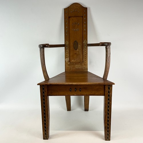900 - A 1922 Eisteddfod chair with fruitwood inlay to legs and back, bowed arm rests with gilt writing dat... 