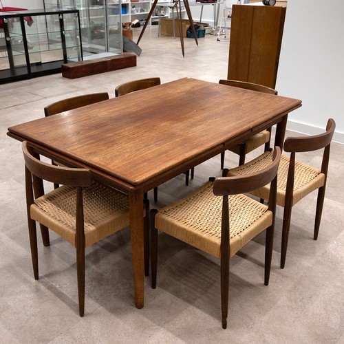 902 - A G-plan style Danish teak drawer leaf dining table of rectangular form, raised on four turned taper... 