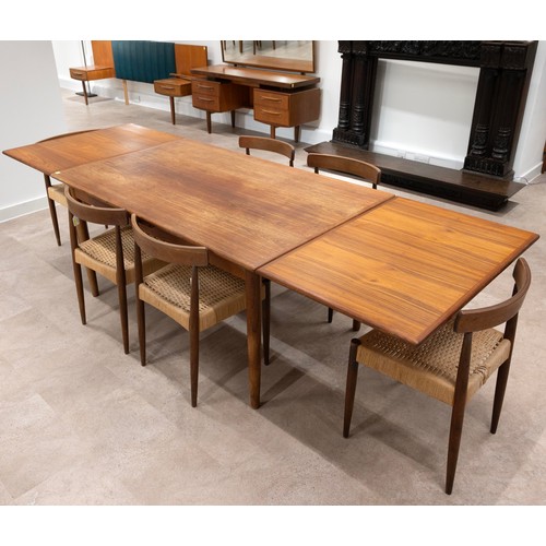 902 - A G-plan style Danish teak drawer leaf dining table of rectangular form, raised on four turned taper... 