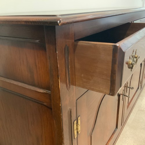 908 - Batheaston oak sideboard, with finely grained top above three drawers with brass drop handles, above... 