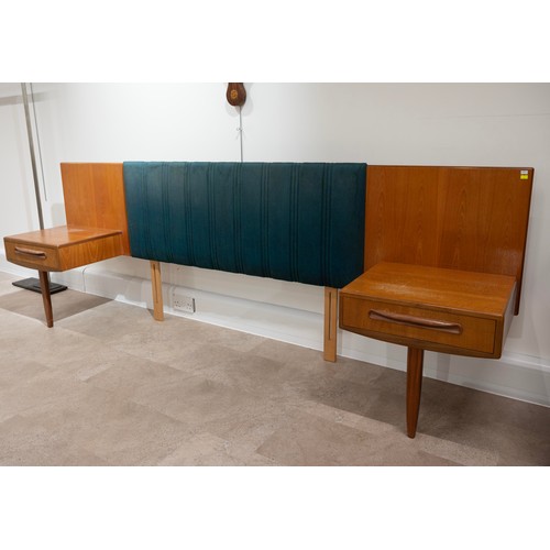 917 - A G-plan teak headboard with padded irredecent fabric with attached single drawer bedside cabinets, ... 