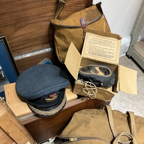 19 - A collection of militaria, to include a gas mask, canvas bags, an RAF officer's hat by Herbert Johns... 