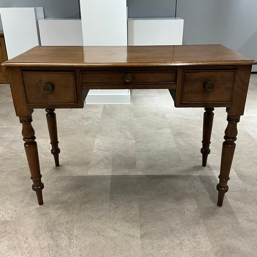 289 - A Victorian mahogany desk, the central drawer flanked by two smaller drawers, raised on turned suppo... 