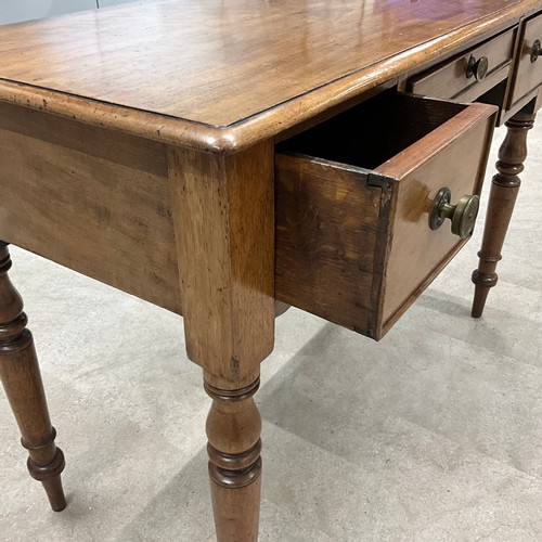 289 - A Victorian mahogany desk, the central drawer flanked by two smaller drawers, raised on turned suppo... 