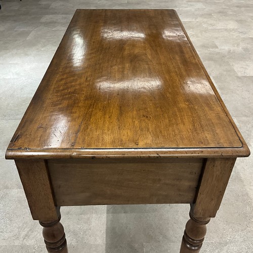 289 - A Victorian mahogany desk, the central drawer flanked by two smaller drawers, raised on turned suppo... 