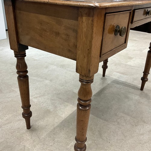 289 - A Victorian mahogany desk, the central drawer flanked by two smaller drawers, raised on turned suppo... 