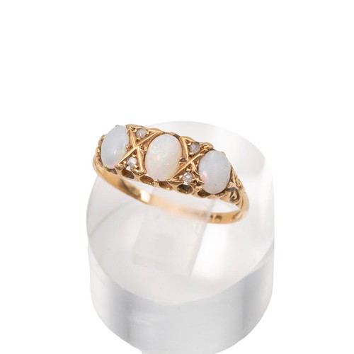 3 - An 18ct gold, three stone opal and diamond ring, the opals displaying a range of colours, set in a d... 