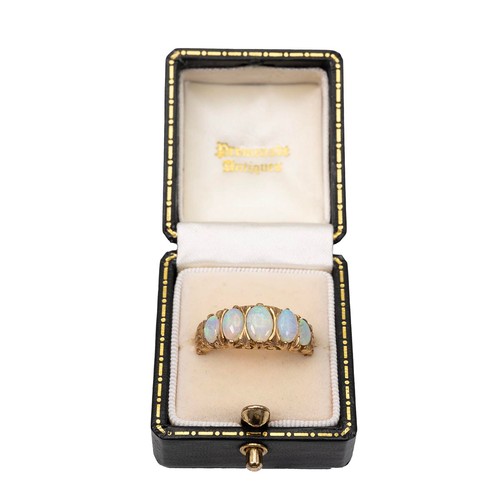 15 - A 9ct gold five stone opal ring, the opals of graduating oval form displaying a full range of colour... 