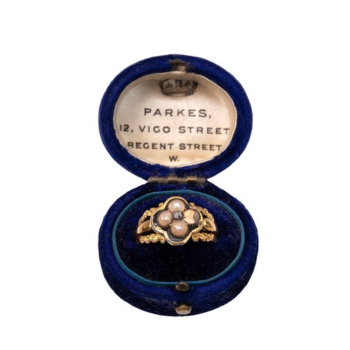 23 - An 18ct (tested) gold mourning ring set with four seed pearls (one missing) and a central rose cut d... 