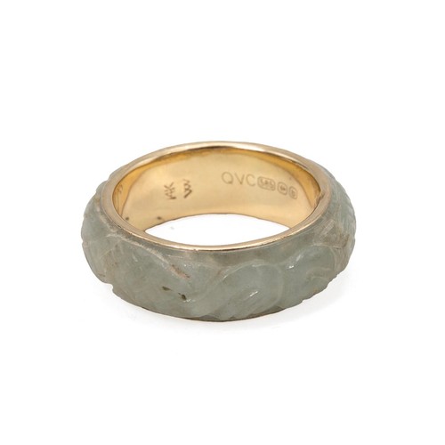 29 - A carved jade 14ct gold ring with carved decoration size N, weight 4.1 grams.