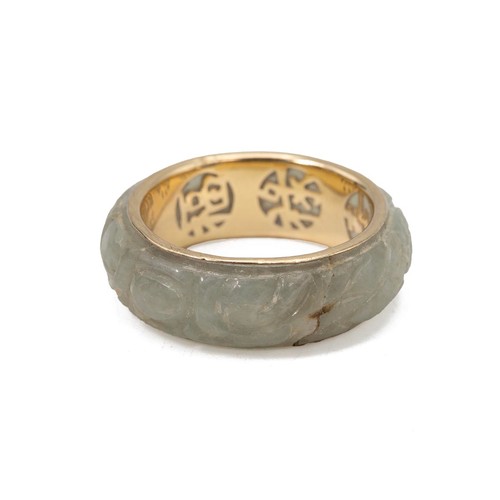 29 - A carved jade 14ct gold ring with carved decoration size N, weight 4.1 grams.