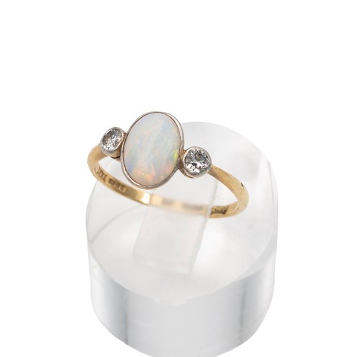52 - An 14ct gold hallmarked opal and diamond ring, the central opal displaying a full range of colours, ... 