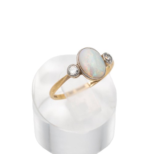 52 - An 14ct gold hallmarked opal and diamond ring, the central opal displaying a full range of colours, ... 