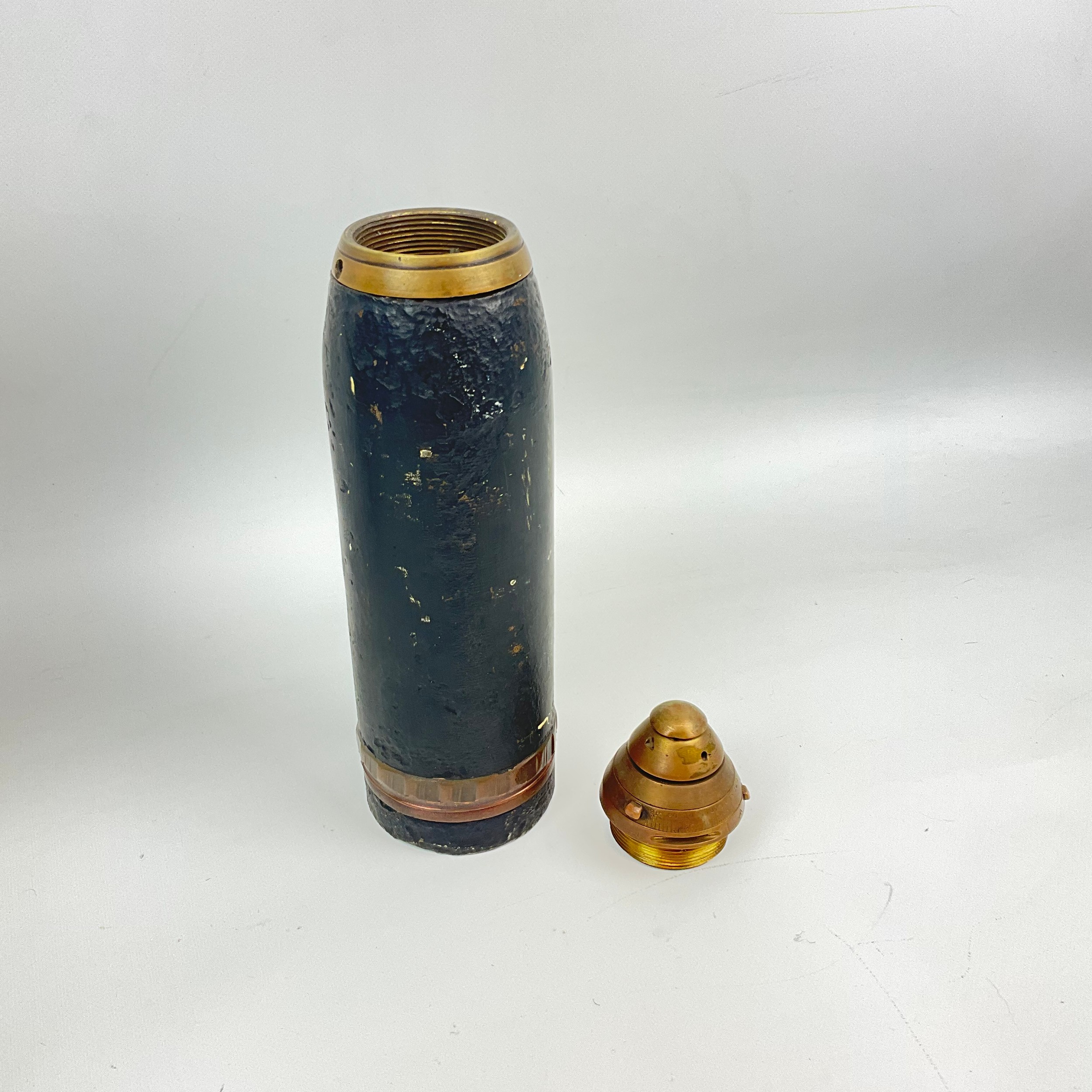 A WWI timed artillery shrapnel projectile and shell, with the shell ...