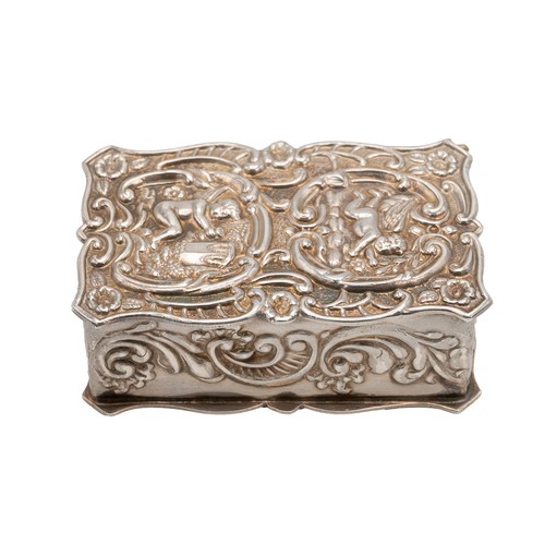 514 - A silver pill box decorated with acanthus flower decorations with two cherubs embossed to lid, hallm... 