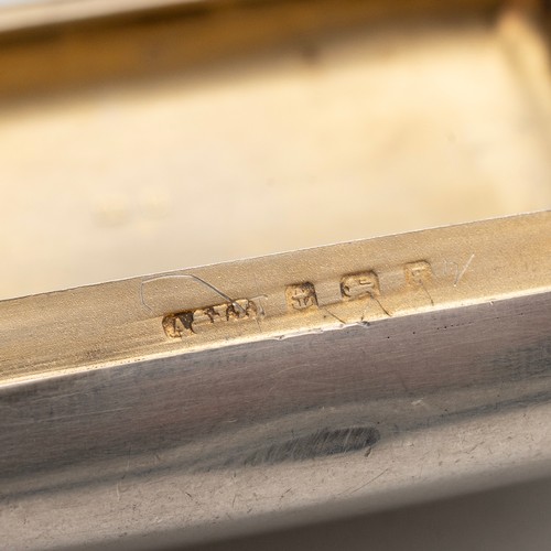 516 - An early 20th-century silver travelling ash-tray with plain exterior with hanging loop and gilt inte... 