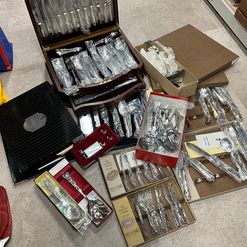 15 - A cased canteen of cutlery and an assortment of boxed flatware.