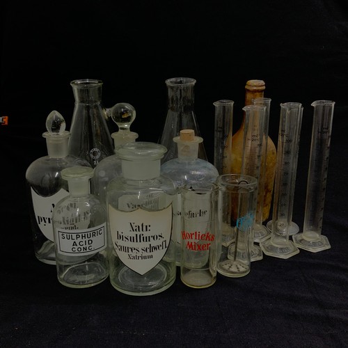 279 - A collection of vintage glass pharmaceutical jars, along with various advertising jars.