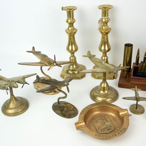 118 - A large collection of cast brass vintage military aeroplanes, including the Spitfire, and a Trench A... 