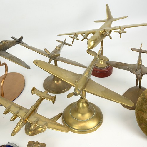 118 - A large collection of cast brass vintage military aeroplanes, including the Spitfire, and a Trench A... 