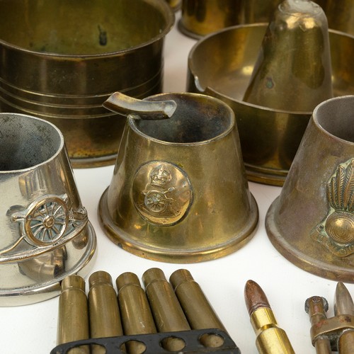 120 - A large collection of WWI Trench Art, including embossed shells, RFC jug, egg cups, ashtrays, etc.