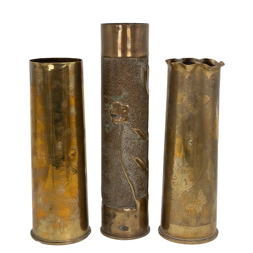 119 - A collection of five artillery shells with embossed and engraved foliate decorations, mixed makers a... 