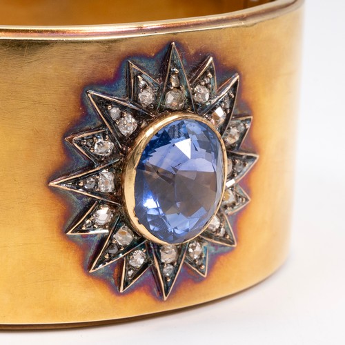 121 - A late 19th-century gold, diamond and sapphire cuff bangle, the oval sapphire measuring approximatel... 