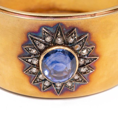 121 - A late 19th-century gold, diamond and sapphire cuff bangle, the oval sapphire measuring approximatel... 