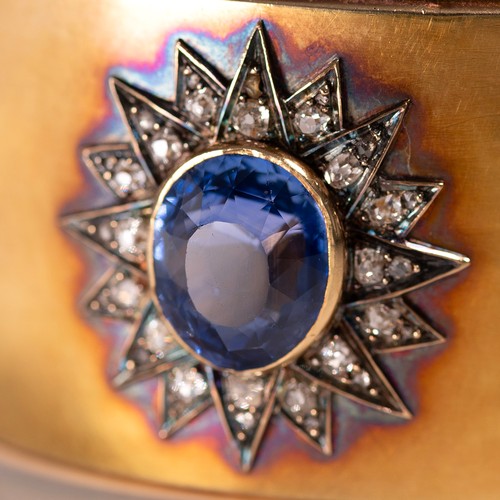 121 - A late 19th-century gold, diamond and sapphire cuff bangle, the oval sapphire measuring approximatel... 