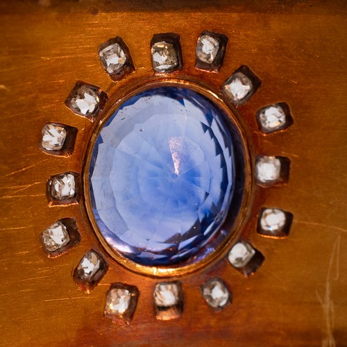 121 - A late 19th-century gold, diamond and sapphire cuff bangle, the oval sapphire measuring approximatel... 