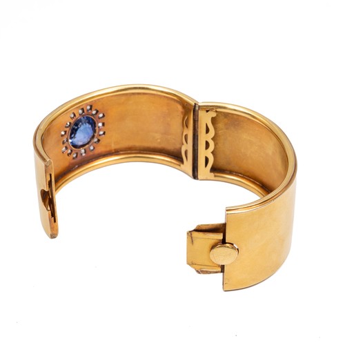 121 - A late 19th-century gold, diamond and sapphire cuff bangle, the oval sapphire measuring approximatel... 